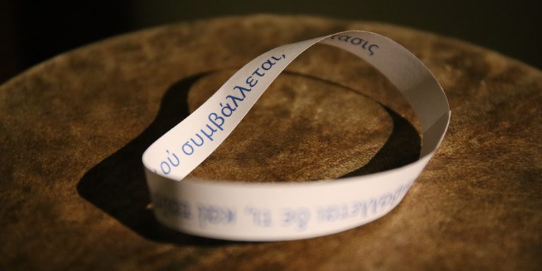 Photograph of Möbius strip with greek lettering