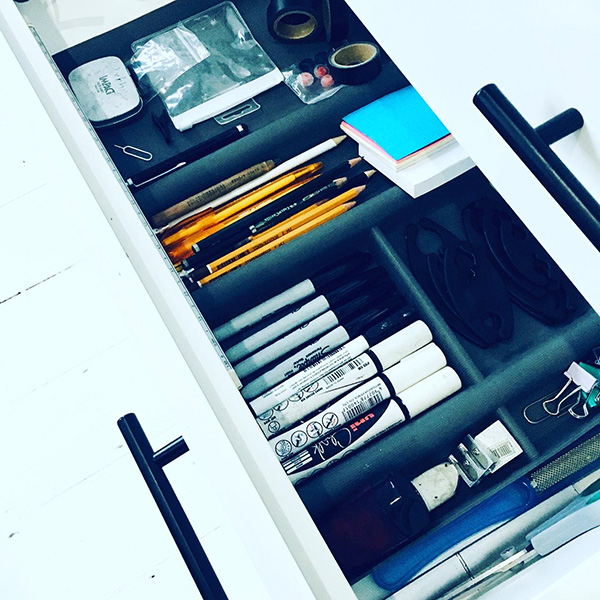 Photograph of stationery nearly arranged in a drawer.