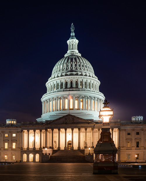 Photograph of the US Capitol building at night