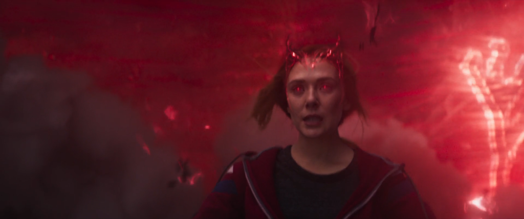 Wanda unleashes her full power. Photo: from Marvel Studios/Disney+ Wandavision (2021). Wanda, a woman with red glowing eyes, is surrounded by a red mist.