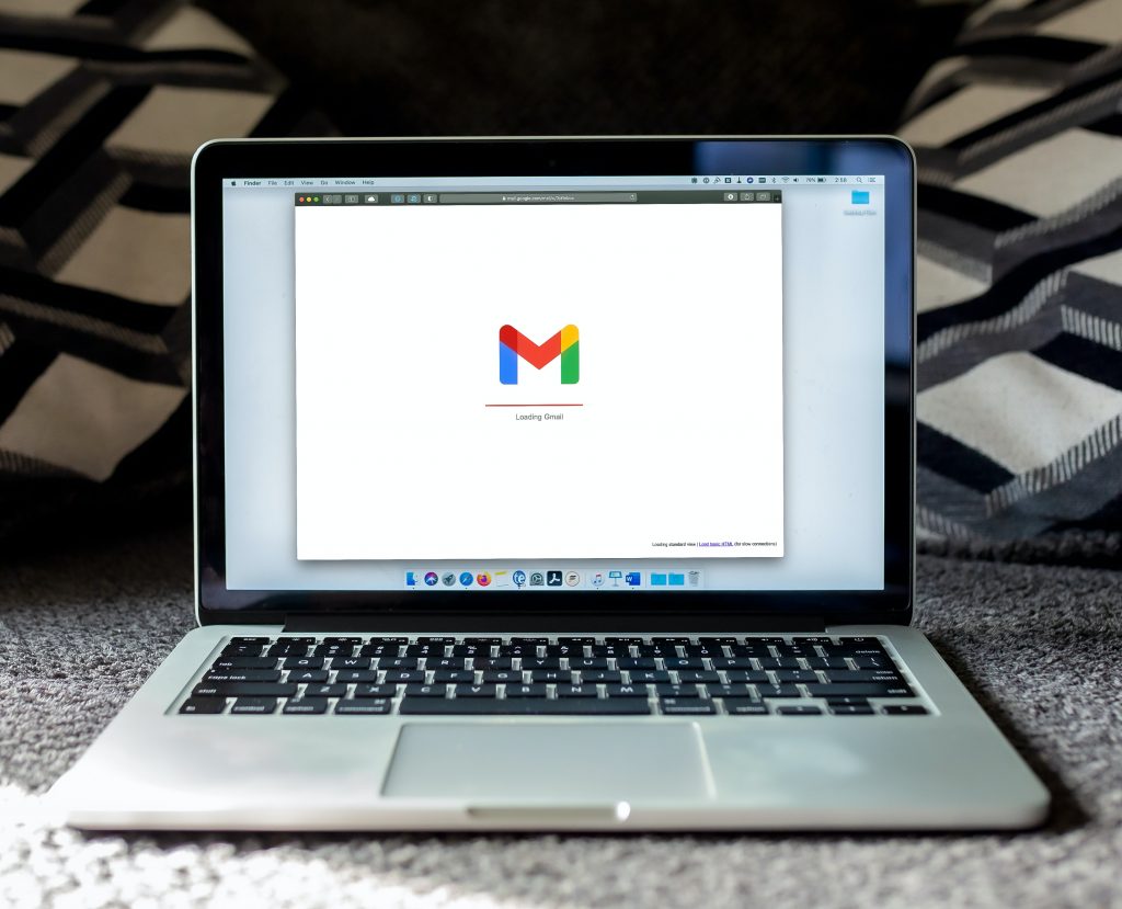 An open Mac laptop with Gmail displayed on the screen