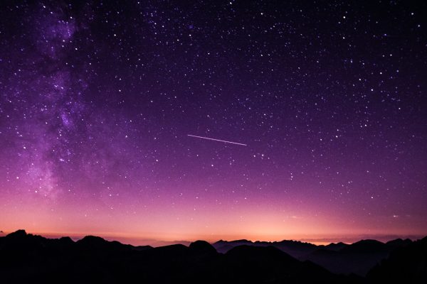 A purple sky with a shooting star
