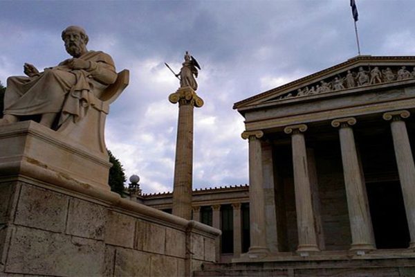 A statue of Plato in front of an Athens government building