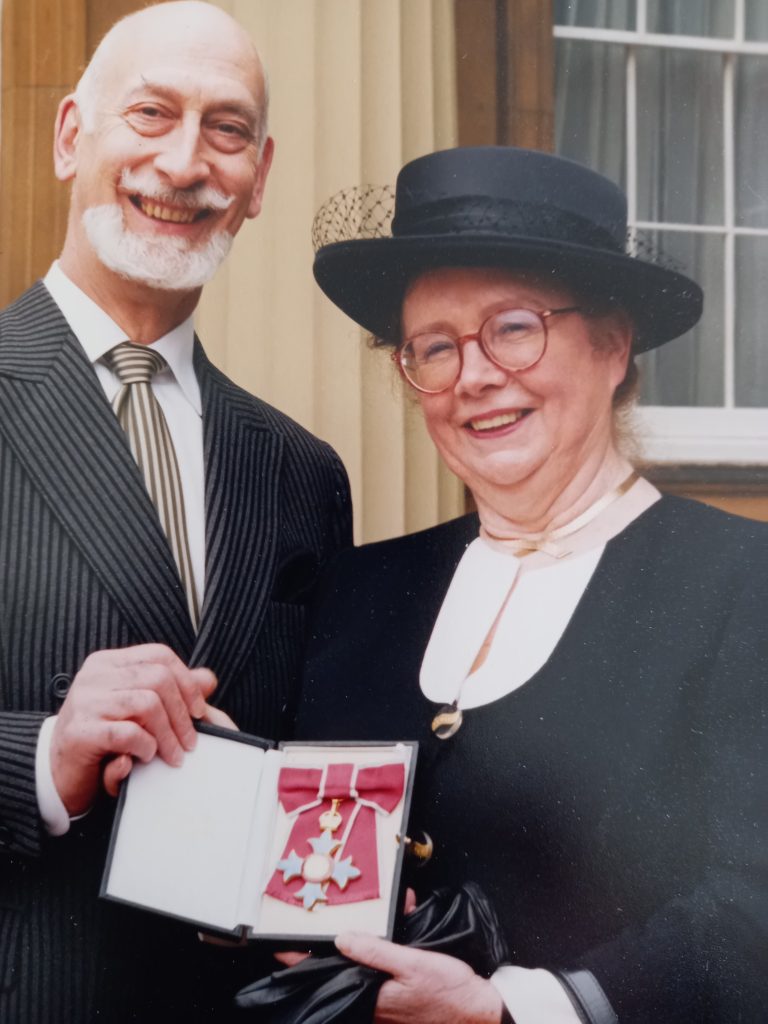Margaret and her husband, 
Professor Sydney Anglo, holding a CBE medal 