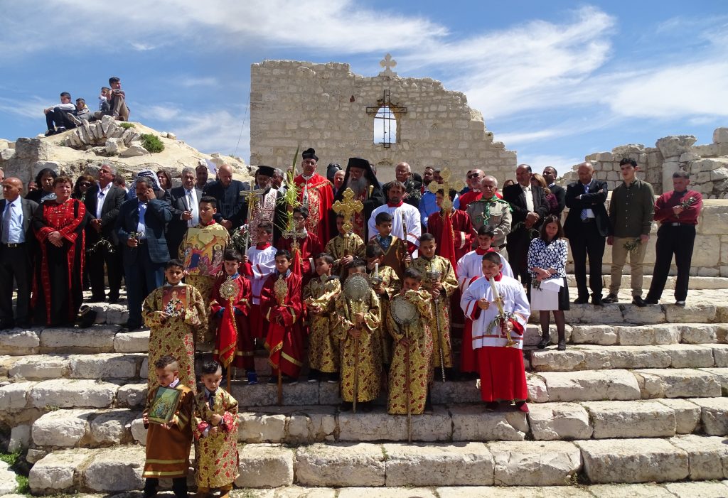A group of people standing on stone steps in religious attire