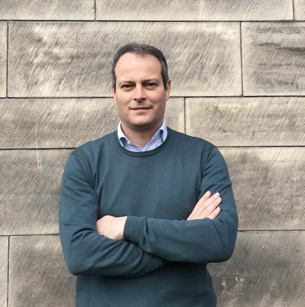 A photo of Dr Ernesto Bonafé wearing a blue jumper