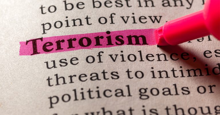 The word terrorism highlighted in pink in a dictionary