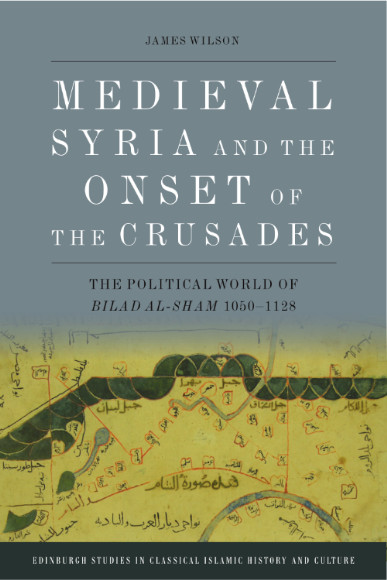 Book cover for Medieval Syria and the Onset of the Crusades: The Political World of Bilad al-Sham 1050–1128 by James Wilson. The cover image shows an extract from a map of bila al-sham (a geographical area encompassing much of the Levant) that James found in a late-5th/11th century manuscript of Ibn Hawqal’s Kitab Surat al-Ard (Book of the Form or Shape of the Earth). The map background is yellow, with black Arabic writing in red boxes connected by red lines, and blue-grey interlocking crescents forming a boundary of some kind horizontally across the map. 