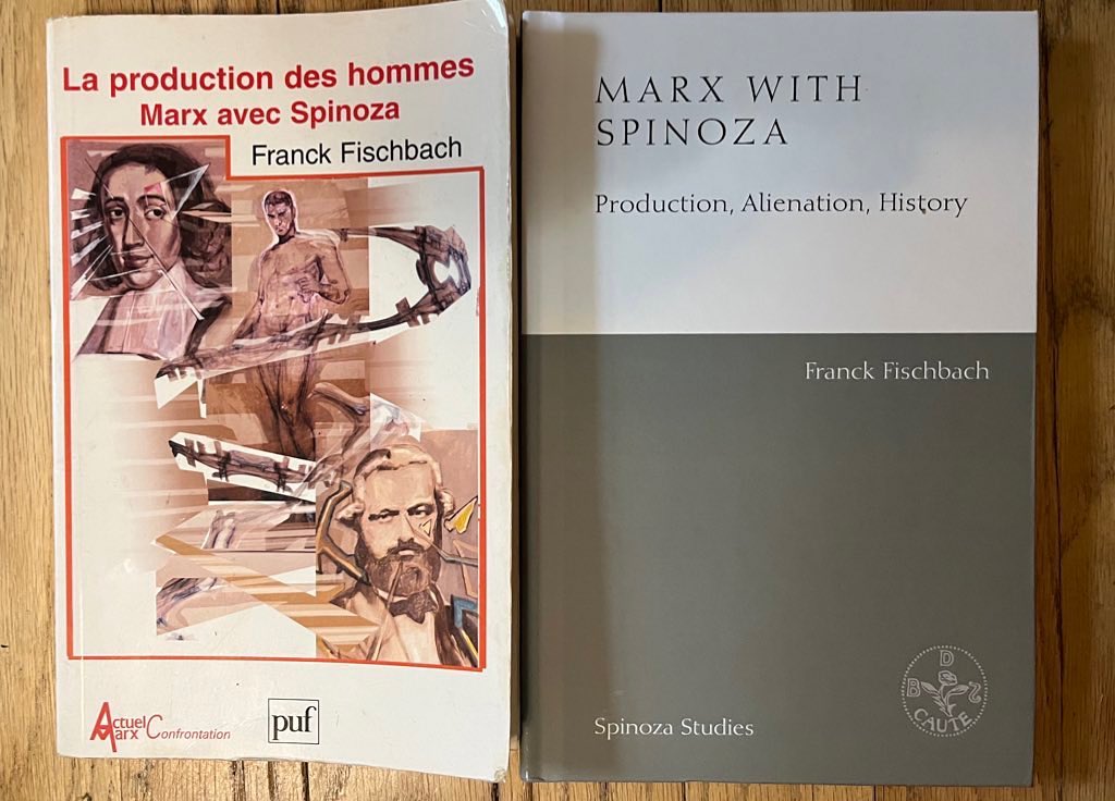 A picture taken by the author, that shows the original 'Marx with Spinoza' book (on the left) and the Edinburgh translation (on the right). The original book jacket is white with a red  rectangular frame closer to the centre of the page which includes three sketches (the top left one is Baruch Spinoza's portrait). The frame is uneven on the top, with the title 'La production des hommes Marx avec Spinoza' on the top in red and the author's name and surname (Franck Fischbach) on the right in black . The book jacket of 'Marx with Spinoza' is divided in two horizontal rectangular parts: The bottom one is olive green with the series title the book is part of (Spinoza Studies) on the bottom left side in white, and the original author's name and surname (Franck Fischbach) on the top right hand side. The top part is white with the title of the book on the top of the page ('Marx with Spinoza') and the subtitle ('Productions, Alienation, History') below it.