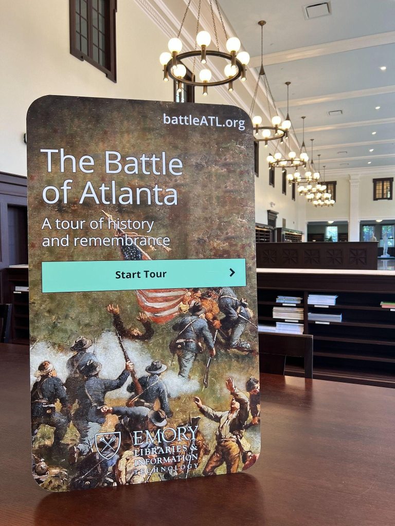 A sign that advertises “The Battle of Atlanta” tour made through Emory’s OpenTour Builder application. Text reads: “battleATL.org, The Battle of Atlanta: A tour of history and remembrance, Emory Libraries and Information Technology.”