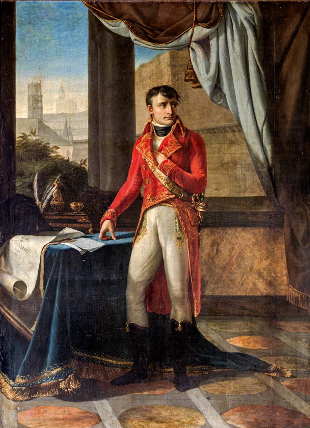 Napoleon stands in a red coat at a table. A curtain lifts up behind him to reveal a cityscape out a window.)