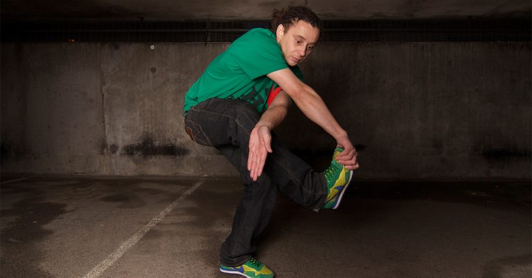 A man in a green shirt dancing