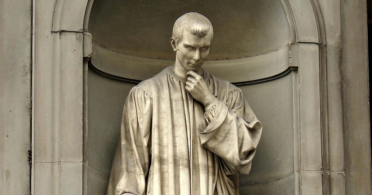 A photograph of the statue of Machiavelli in Florence: he has his hand raised to his chin in thought