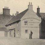 Black and white image showing the gable end of a house-like building with a figure standing in front of it. Text on the building reads 'Poosie Nansie's Hostelry and the Jolly Beggars Howf Posting Establishment'.