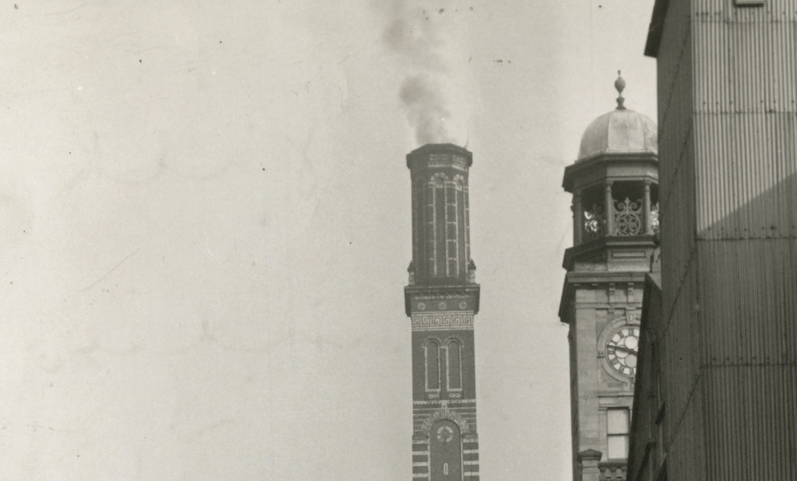 black and white picture of a chimney stack and a bell tower