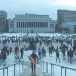 Photograph of Columbia University in the snow, with crowds of people enjoying the weather