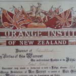 Certificate with text contained within two pillars, and a ceiling showing Union Jack flags and a man on horseback. The text reads 'Loyal Orange Institution of New Zealand. District of Christchurch. By virtue of this Warrant our well-beloved brother of the Purple Order Robert Roberts and each Successor duly elected is Authorised to hold a Lodge, number 32A, of the Loyal Orange Institution of New Zealand, to consist of True Orangement and to act as Master in conformity with the Constitution and Rules.