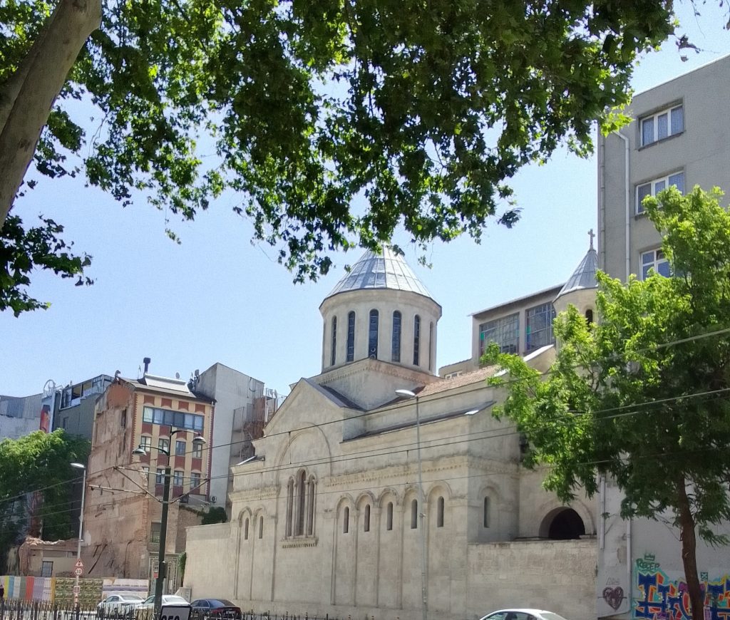 An exterior view of a church building facing a street.