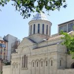 An exterior view of a church building facing a street.