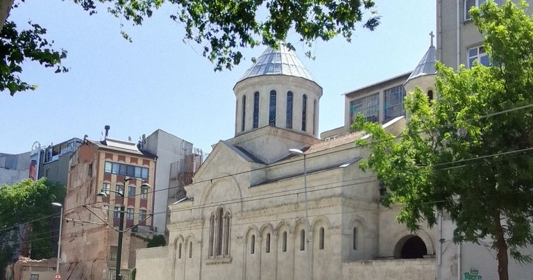 An exterior view of a church building facing a street.