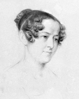 Black and white portrait of a woman with curly hair, partially tied back. She is looking slightly to her left with a neutral expression.