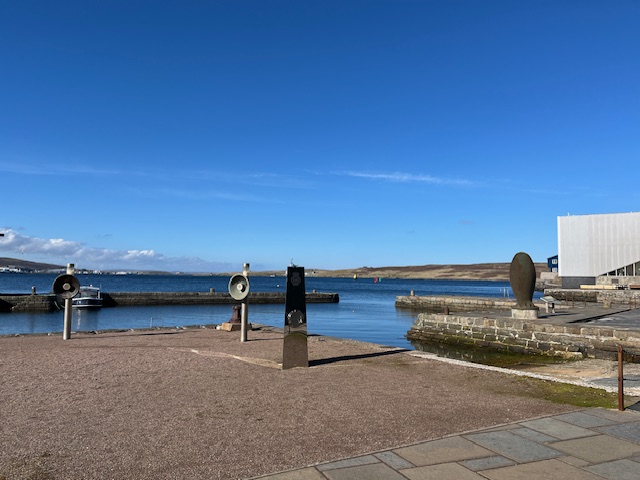 A harbour with a bay and a town on the far shore.