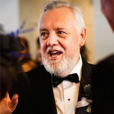 A candid shot of Paul Watchman in a three-piece suit.