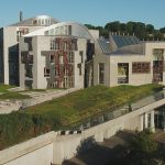 An aerial photograph of the Scottish Parliament building at the bottom of the Royal Mile, Edinburgh