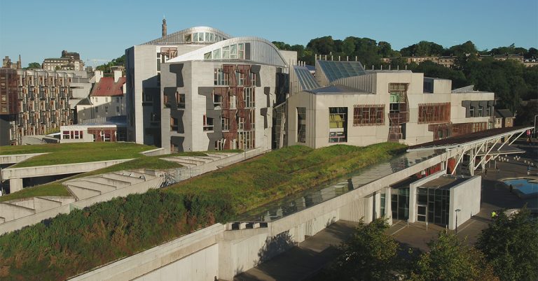An aerial photograph of the Scottish Parliament building at the bottom of the Royal Mile, Edinburgh