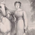 Young white woman standing next to a white horse.