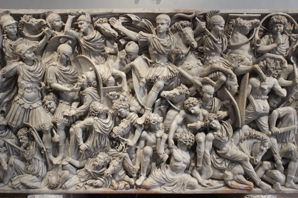 Roman and barbarian soldiers are fighting against each other.