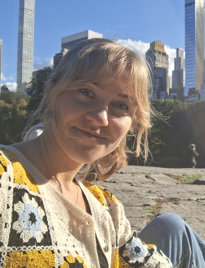 A selfie of the author sitting in a park in the sun. 