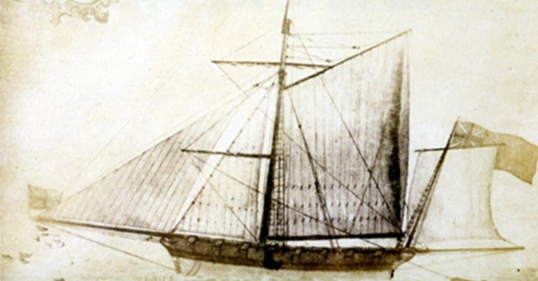 A sepia-toned historical drawing of a sailing ship with two masts. The vessel is shown in profile, featuring multiple rigging lines and sails—some raised and some partially furled. Small flags fly from the masts and stern. The style looks like an old technical or naval illustration, with fine line work detailing the ship’s structure and rigging.